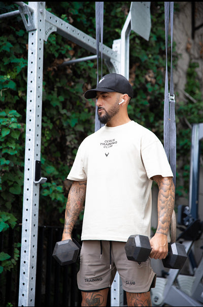 Cerus Beige Flow Training Club T-Shirt – front view with logo detail.